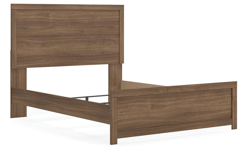 Ashley Furniture Broachmyn Bed with a stylish wooden frame, shown from an angled view in a modern bedroom setting.