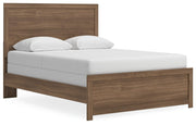Ashley Furniture Broachmyn Bed with a stylish wooden frame, shown from a side-angle perspective in a modern bedroom setting.
