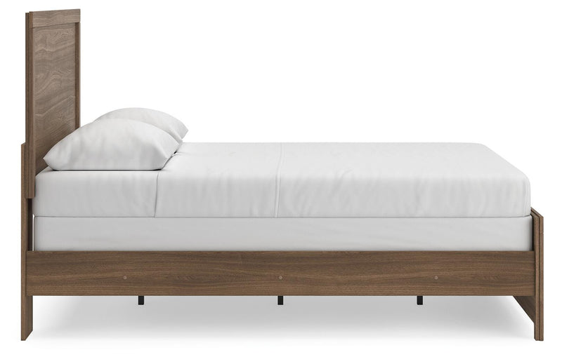 Ashley Furniture Broachmyn Bed with a wooden frame, headboard, and side view showing the elegant design and finish.