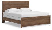 Ashley Furniture Broachmyn Bed in a stylish bedroom setting with a wooden headboard and neutral bedding, angled view showing design details.
