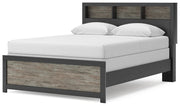 Ashley Furniture Broachmyn Bed with a stylish headboard and frame, shown from an angled side view in a modern bedroom setting.