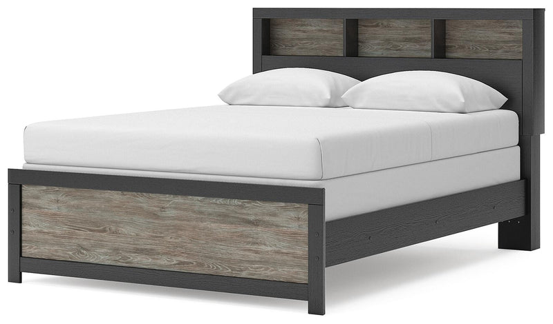Ashley Furniture Broachmyn Bed with a stylish headboard and frame, shown from an angled side view in a modern bedroom setting.
