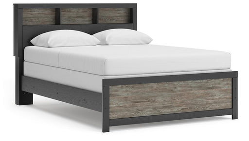 Ashley Furniture Broachmyn Bed shown from a southwest angle, featuring a wooden frame and detailed headboard design.