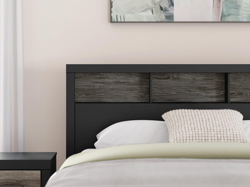 Ashley Furniture Broachmyn Bed with a detailed wooden headboard and frame in a natural finish, shown in a stylish bedroom setting.