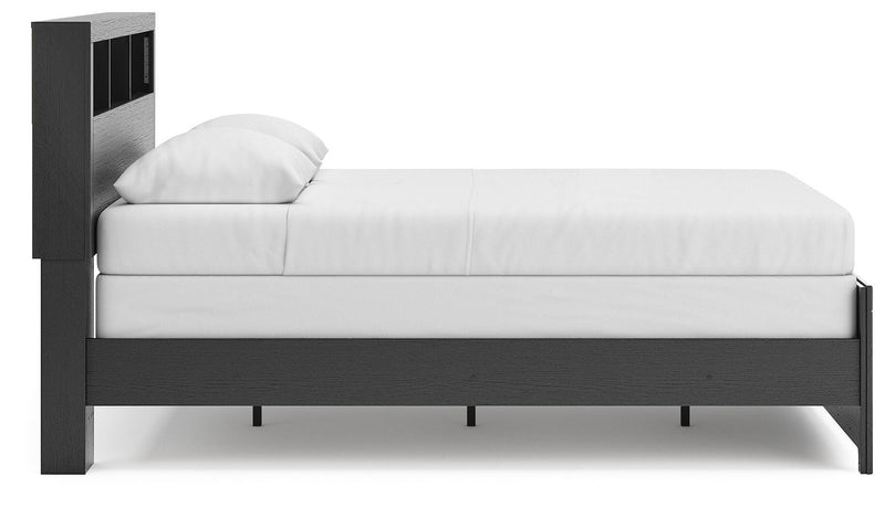 Ashley Furniture Broachmyn Bed with side view, showcasing its elegant frame and detailed headboard design.