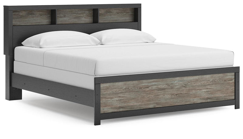 Ashley Furniture Broachmyn Bed shown from an angle, featuring a stylish bed frame with a wooden finish and classic design.