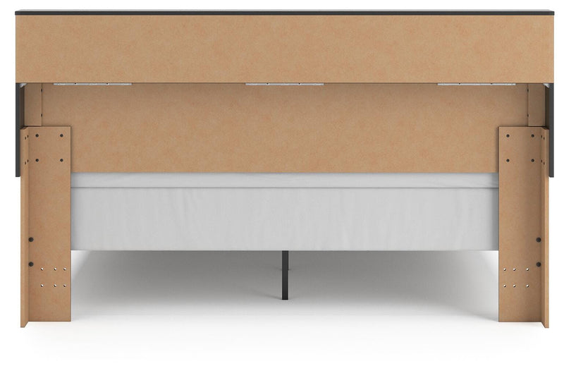 Ashley Furniture Broachmyn Bed with a dark wood finish and elegant headboard design, shown from the back view.