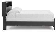 Ashley Furniture Broachmyn Bed with side view showcasing its elegant wooden frame and detailed headboard design.