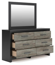 Ashley Furniture Broachmyn dresser with mirror, showing open drawers and elegant wood finish from a side angle.