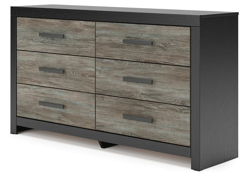 Ashley Furniture Broachmyn dresser and mirror set, showcasing a wooden dresser with a matching mirror in a modern bedroom setting.