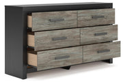 Ashley Furniture Broachmyn dresser with mirror, features a wooden finish and spacious drawers, shown from an angled open view.