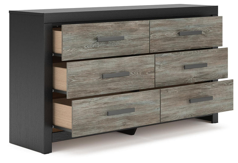 Ashley Furniture Broachmyn dresser with mirror, features a wooden finish and spacious drawers, shown from an angled open view.