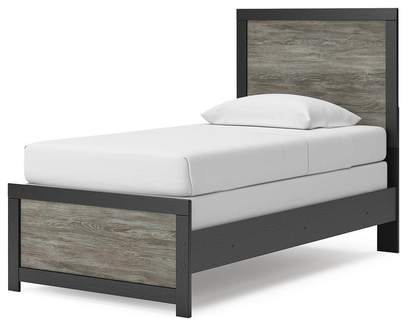 Angled view of the Broachmyn Bed by Ashley Furniture, showcasing its elegant wooden frame and upholstered headboard.