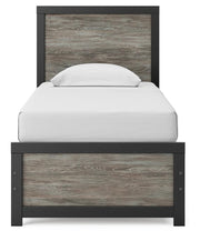 Ashley Furniture Broachmyn Bed with a headboard featuring detailed woodwork and a dark finish, shown from a front angle.