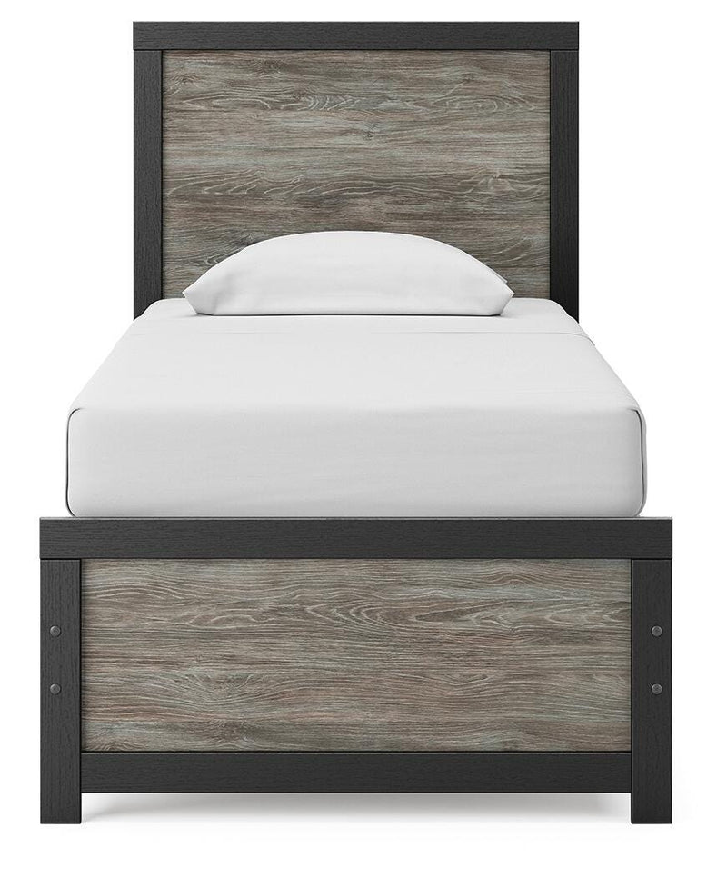 Ashley Furniture Broachmyn Bed with a headboard featuring detailed woodwork and a dark finish, shown from a front angle.