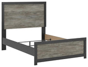 Ashley Furniture Broachmyn Bed with a wooden frame and upholstered headboard, shown from an angled view in a modern bedroom setting.