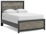 Ashley Furniture Broachmyn Bed with a stylish wooden frame and upholstered headboard, shown from an angled side view.