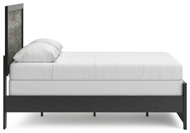 Ashley Furniture Broachmyn Bed with elegant wooden frame and headboard, showcasing a contemporary bedroom furniture design.