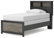 Ashley Furniture Broachmyn Bed with a wooden frame and upholstered headboard, shown from an angled view.