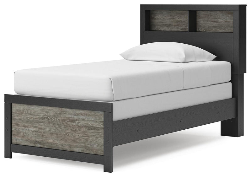 Ashley Furniture Broachmyn Bed with a wooden frame and upholstered headboard, shown from an angled view.