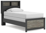 Ashley Furniture Broachmyn Bed in a bedroom setting, showcasing its wooden frame and stylish design from a side angle.