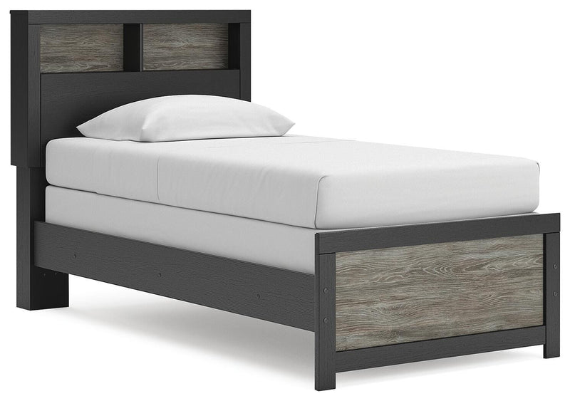 Ashley Furniture Broachmyn Bed in a bedroom setting, showcasing its wooden frame and stylish design from a side angle.