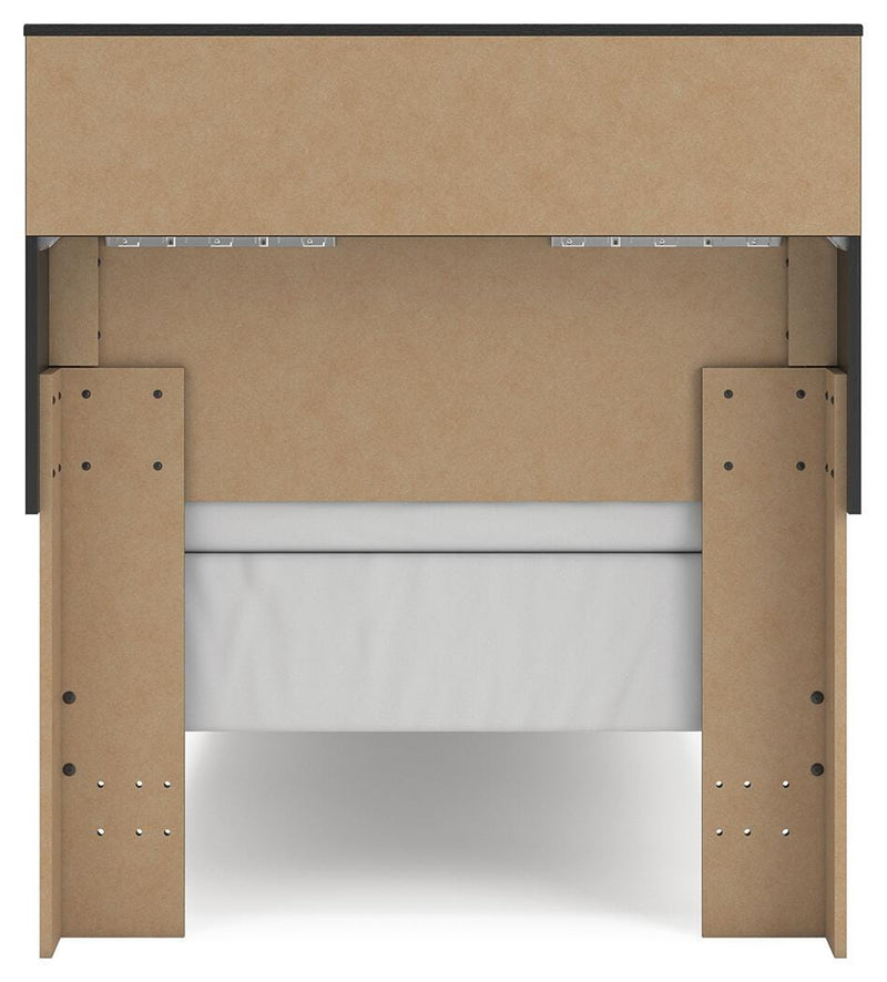 Ashley Furniture Broachmyn Bed with a wooden frame, headboard, and detailed design in a cozy bedroom setting.