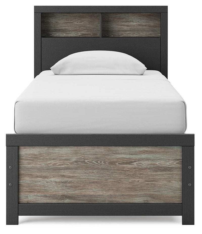 Ashley Furniture Broachmyn Bed with upholstered headboard and wooden frame, shown from a front angle.