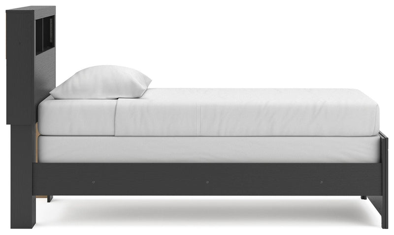 Ashley Furniture Broachmyn Bed with a stylish wooden frame and neutral upholstery, shown from a side view.