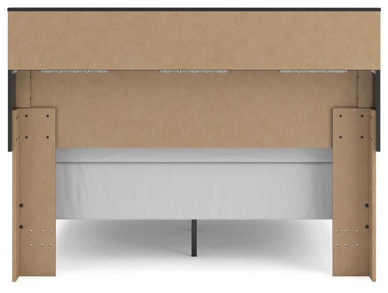 Ashley Furniture Broachmyn Bed with a stylish headboard, shown in a cozy bedroom setting with neutral bedding and modern decor.