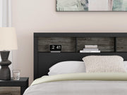 Ashley Furniture Broachmyn Bed with detailed wood finish and classic design, shown in a well-made bedroom setting.