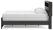 Ashley Furniture Broachmyn Bed with a wood finish and elegant design, shown from the side view highlighting its frame and headboard details.