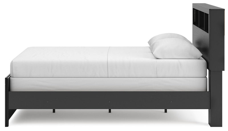 Ashley Furniture Broachmyn Bed with a wood finish and elegant design, shown from the side view highlighting its frame and headboard details.