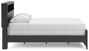 Ashley Furniture Broachmyn Bed in a stylish bedroom setting with a neutral-toned headboard and bedding.