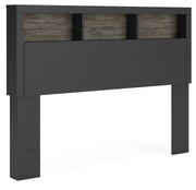 Angle view of Ashley Furniture Broachmyn Bed showcasing its elegant wood frame and detailed headboard design.