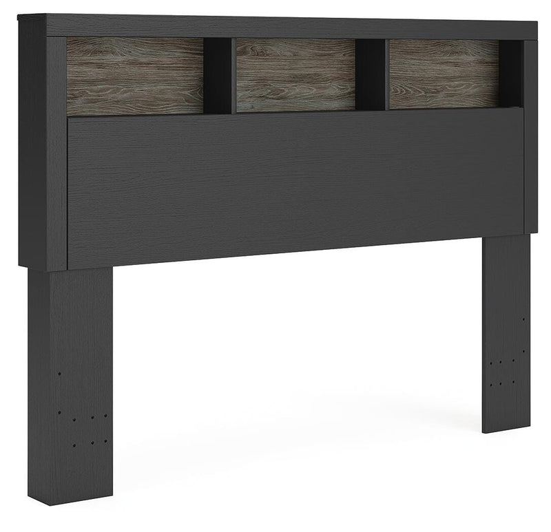 Angle view of Ashley Furniture Broachmyn Bed showcasing its elegant wood frame and detailed headboard design.