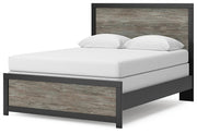 Ashley Furniture Broachmyn Bed with a stylish upholstered headboard and wooden frame, shown from an angled view.