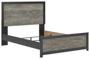 Ashley Furniture Broachmyn Bed in a stylish dark wood finish, shown from an angled side view with a paneled headboard