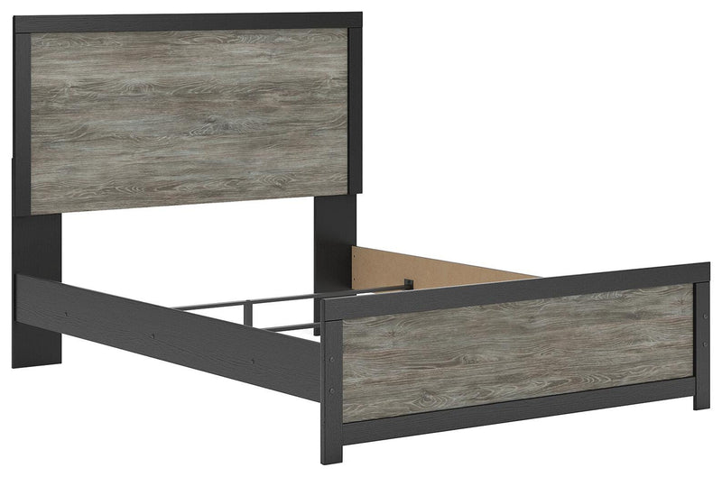 Ashley Furniture Broachmyn Bed in a stylish dark wood finish, shown from an angled side view with a paneled headboard