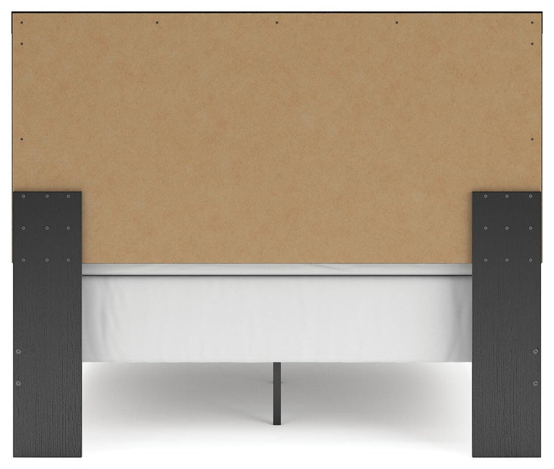 Ashley Furniture Broachmyn Bed with a dark wood finish, showcasing the headboard and elegant design details.