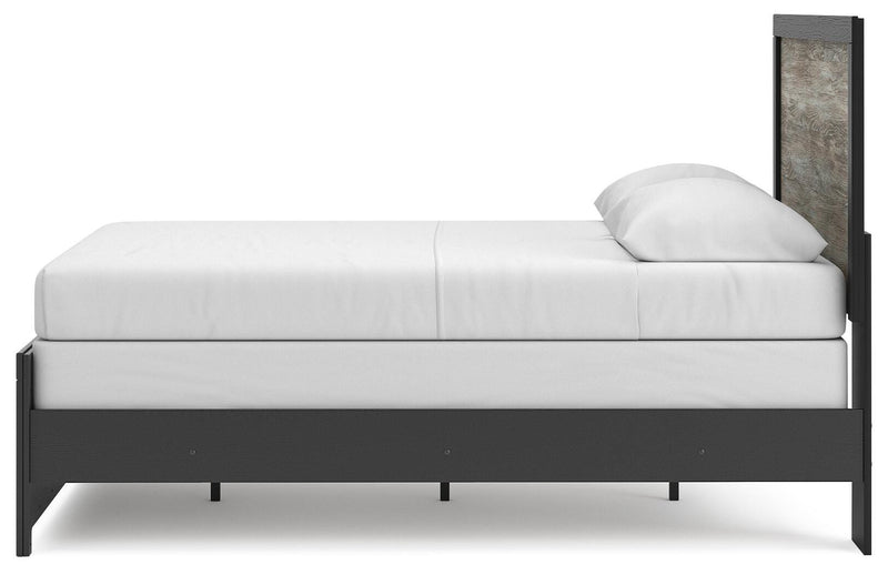 Ashley Furniture Broachmyn Bed with a modern design, showcasing its elegant wooden frame and neutral fabric upholstery.