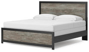 Ashley Furniture Broachmyn Bed with a stylish upholstered headboard and wood frame, shown from an angled view.