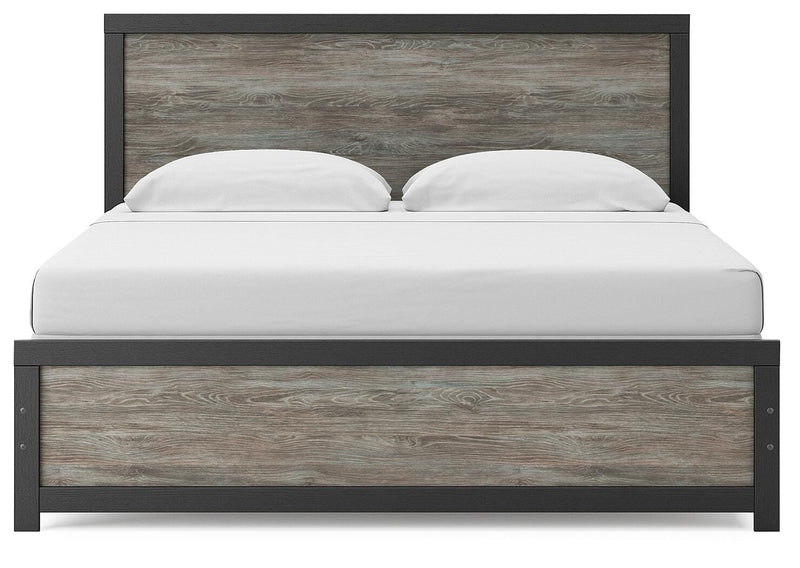 Ashley Furniture Broachmyn Bed with a headboard featuring intricate wood details, in a stylish bedroom setting.