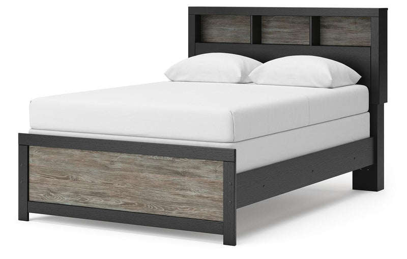Ashley Furniture Broachmyn Bed with a modern design, showcasing its sleek frame and upholstered headboard from a side angle.