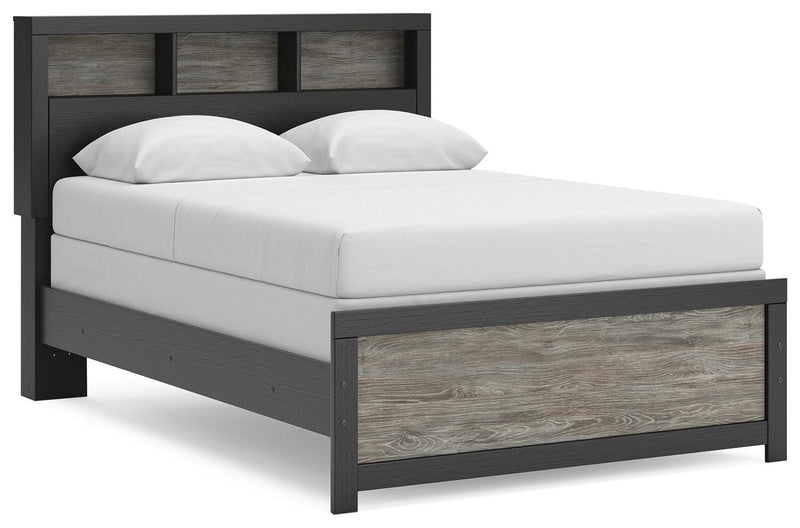 Ashley Furniture Broachmyn Bed with a stylish wooden frame, shown from a side angle in this image.