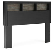 Ashley Furniture Broachmyn Bed, angle view showing wooden frame and headboard in a modern bedroom setting.