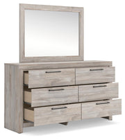 Ashley Furniture Broachmyn dresser and mirror set with open drawers, showcasing a stylish bedroom storage and decor piece.