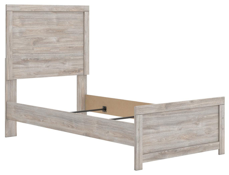 Ashley Furniture Broachmyn Bed with a sleek, modern design featuring a sturdy frame and stylish headboard in a cozy bedroom setting.