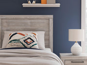 Close-up of Ashley Furniture Broachmyn Bed showing detailed headboard with carved wood design and rich finish.