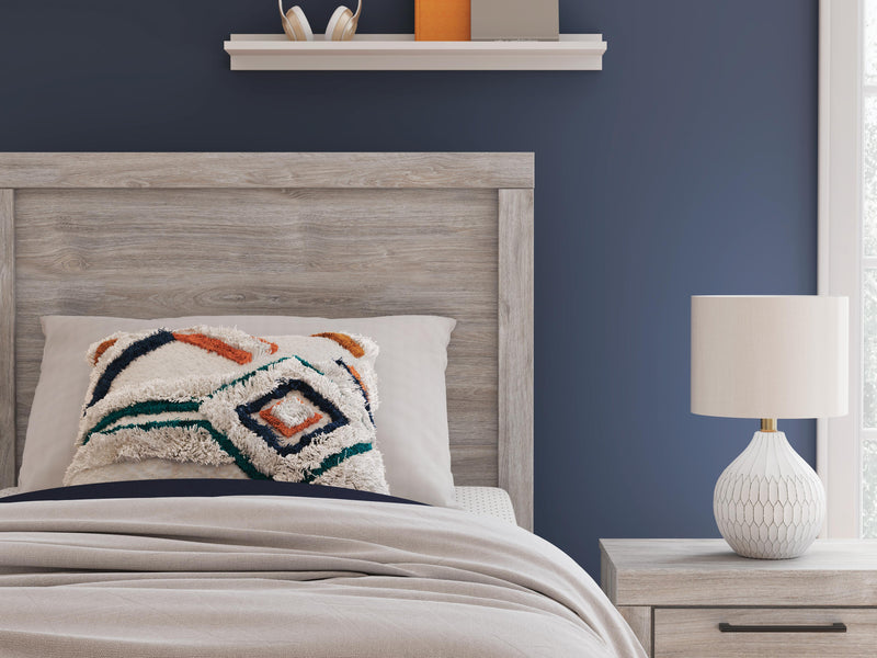 Close-up of Ashley Furniture Broachmyn Bed showing detailed headboard with carved wood design and rich finish.